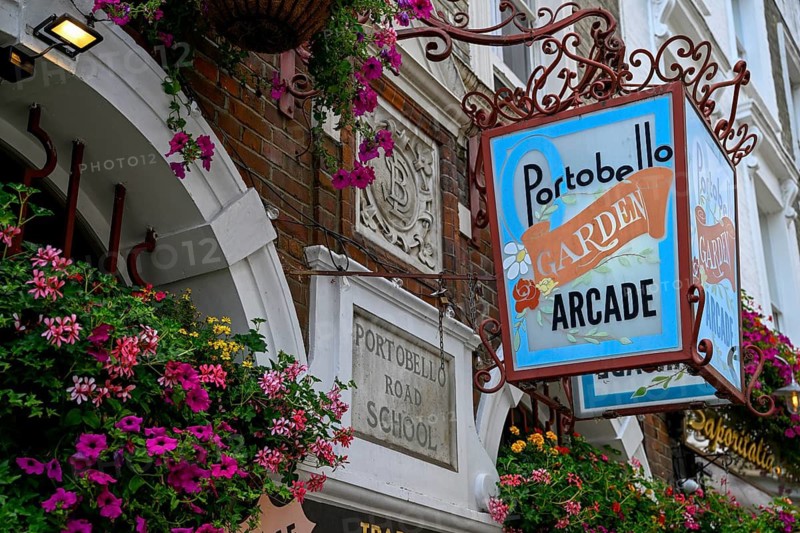 Detailed view of Portobello Garden Arcade entrance sign with floral decoration, Portobello Road, Notting Hill, Royal Borough of Kensington and Chelsea, London, England, Great Britain, Great Britain