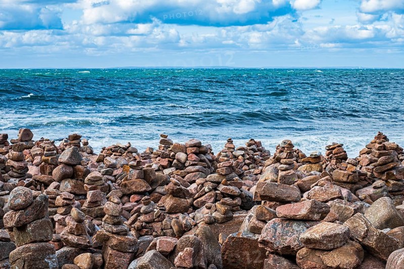 Picturesque coastal landscape full of stone men, near Hovs Hallar, a nature reserve near Bastad, Skåne, Sweden. Picturesque coastal scenery dotted with cairns, at Hovs Hallar, a nature reserve near Bastad, Scania, Sweden