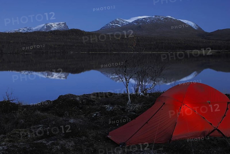 Bivouac, tent by a lake in Abisko National Park with Lapporten reflected in the water, Norrbotten, Lapland, Sweden, Scandinavia