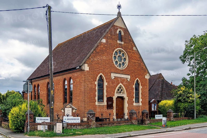 Red brick former Wesleyan Methodist chapel of 1877 with rose window and gothic arches, now converted to offices, Aylesbury Road, Bierton, Buckinghamshire, United Kingdom