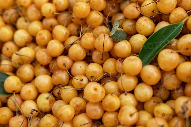 Yellow cherries with leaves at a market