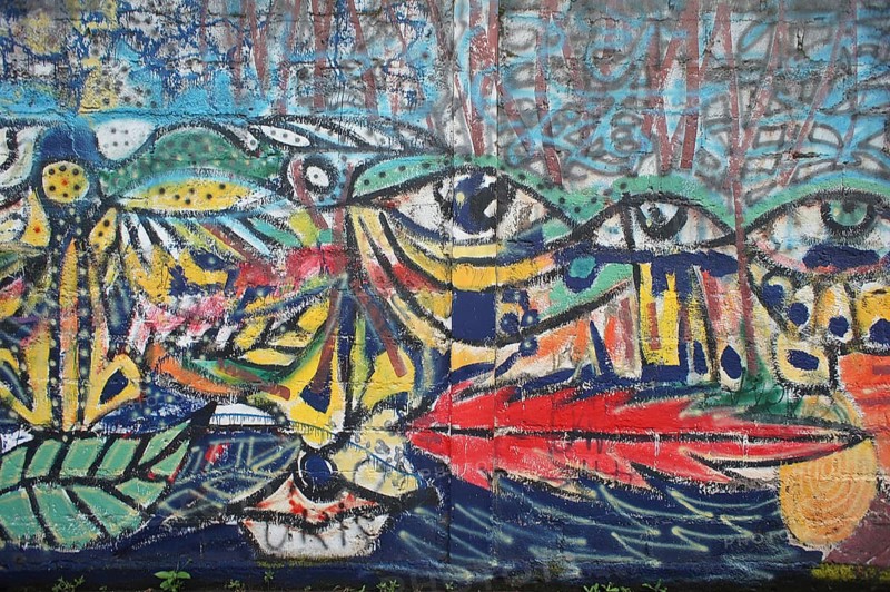 Colorful wall mural, graffiti with eye motifs and colorful, abstract shapes, Ecuador