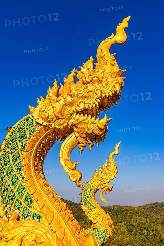 Gilded dragon figure at the stairway to the Buddhist temple Wat Phra That Don Phra Chan, near Lampang, Lampang province, Thailand