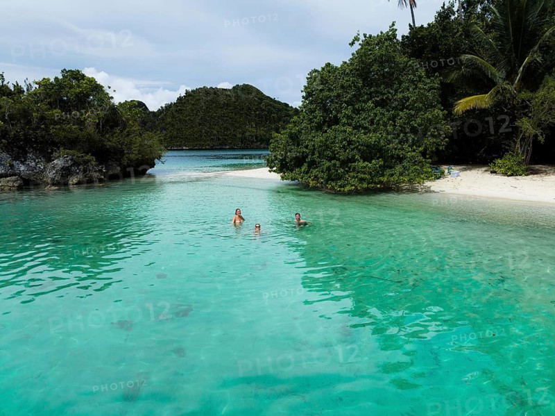 Aerial view of travelers in a lagoon, Wayag Archipelagio, West Papua, Indonesia