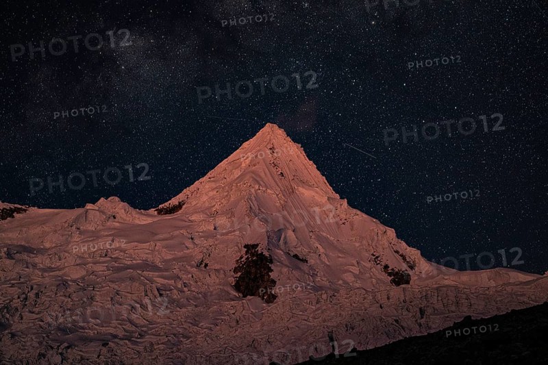 Alpamayo with alpamayo glacier against a starry sky, 5947 m, with the title of most beautiful mountain in the world, Cordillera Blanca, Huascaran National Park, northern Peru, Peru, South America