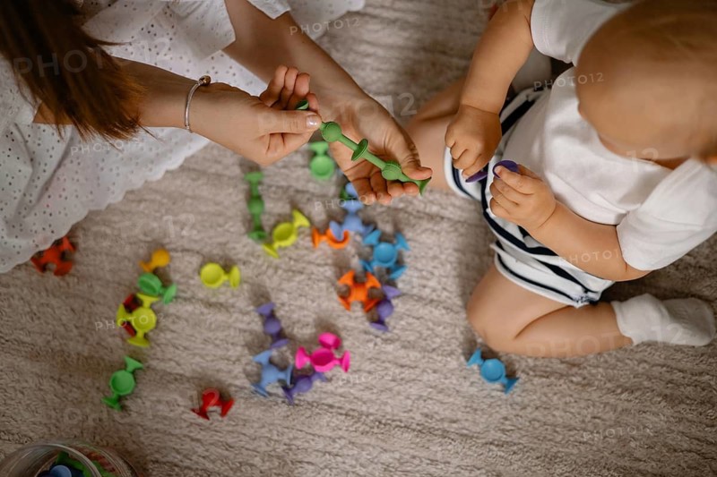 A colorful scene of a mother and child playing with vibrant toys, exuding joy and connection