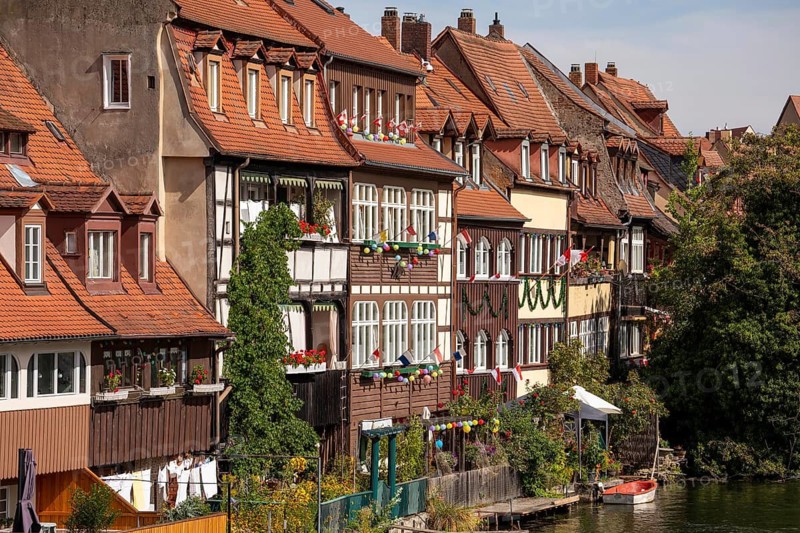 20 August 2026, decorated historic half-timbered houses along the Regnitz river during the Sandkerwa festival in Bamberg, Bavaria, Germany