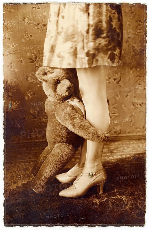 Childhood, memory, affection, hug, staging, feeling, twenties, teddy bear hugging a woman's legs, stylish retro feeling in sepia tone, 1926
