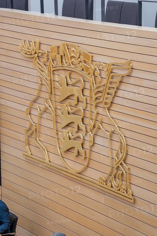 Large golden coat of arms on a wooden wall inside a building, state parliament of Baden-Württemberg, Stuttgart, Germany