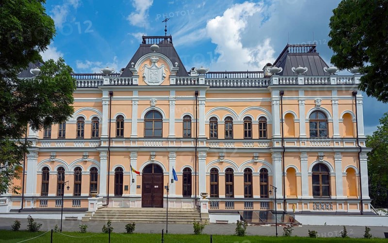 A historic building with an elaborate façade and several flags on the front, Manuc Bey Castle, Hîncesti, Hincesti, Republic of Moldova, Moldova