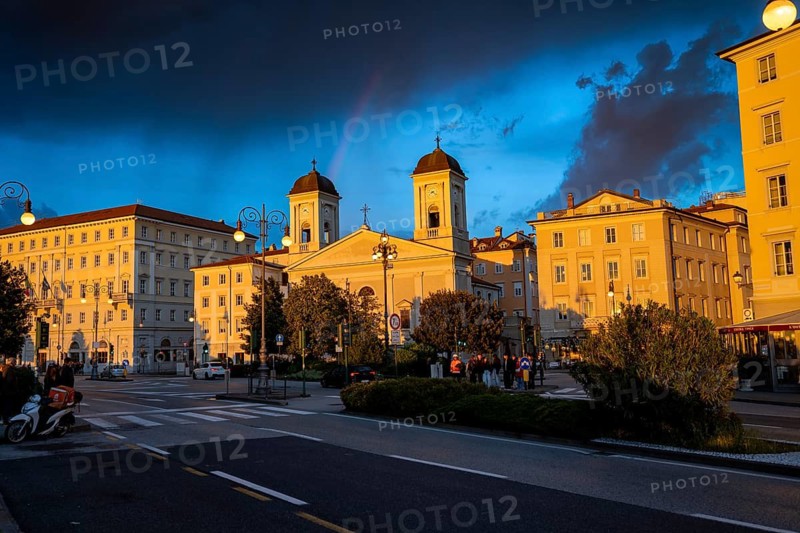 Magnificent buildings and Greek Orthodox church San Nicolò on the Riva del Mandracchio seafront in the evening light at sunset, dramatic clouds, Trieste, Friuli-Venezia Giulia region, Italy