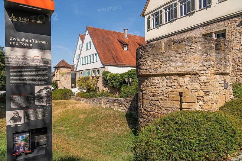 City wall with roundel defence tower and city moat, old town of Marbach am Neckar, historic city fortification, medieval town, city history, medieval townscape, fortification tower, masonry, defensive wall, defensive structure, city gate, fortress, city moat, historic architecture, half-timbered houses, Neckar area, medieval period, monument, cultural monument, historical landmark, information board, gabled houses, green spaces, Baden-Württemberg, Germany