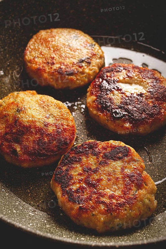 Fried chicken cutlets, with vegetables, in a frying pan, homemade, no people