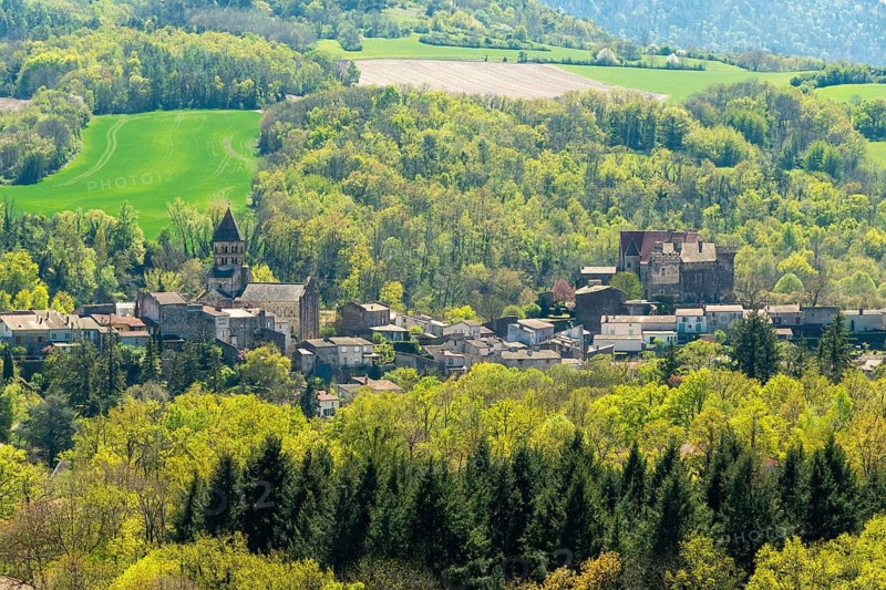 View of the Romanesque church and the castle of Saint-Saturnin village, Puy de Dome department, Auvergne-Rhone-Alpes, France