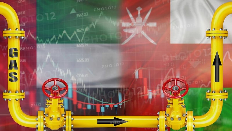 Gas exports from the United Arab Emirates to Oman on financial chart background. Emirati gas export pipeline to Oman