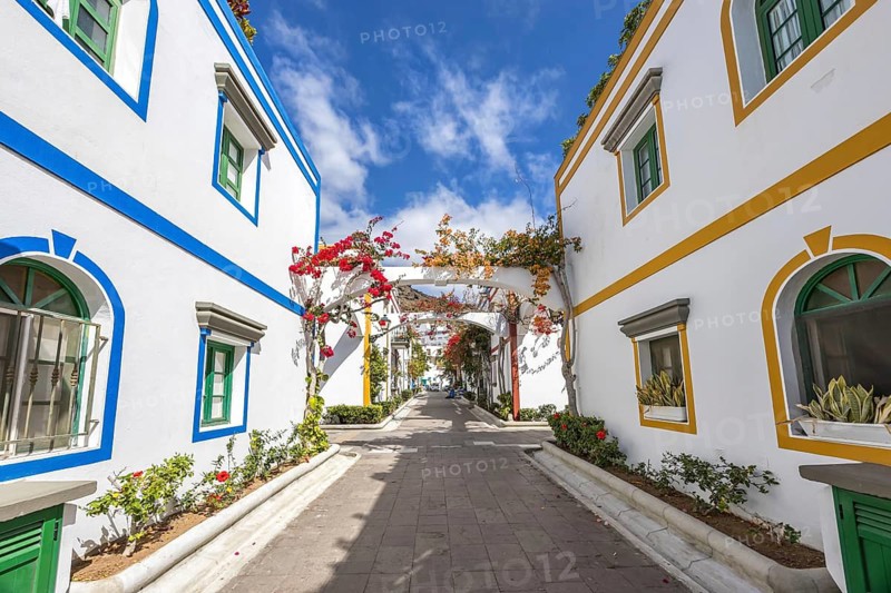 Puerto de Mogan typical colorful houses with flowers on Gran Canaria island vacation trip in Puerto de Mogán, Spain