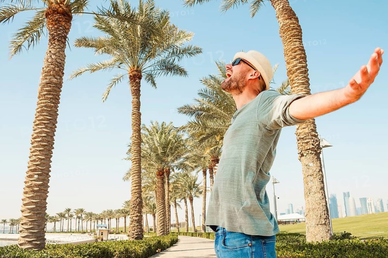Caucasian excited man enjoy summer vacation on tropical resort beach, fun carefree tourist man. Portrait of handsome european man on beach smiling laughing on summer holiday vacation travel lifestyle