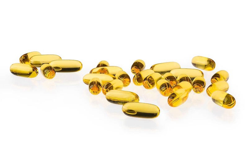 Omega 3 capsule scattered on white background (photo with full depth of field)