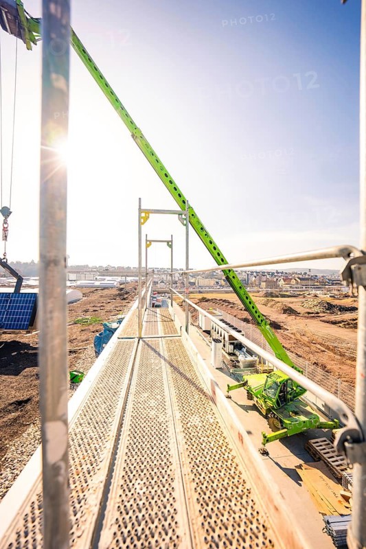 Sunny construction site with scaffolding and clear blue sky in the background, PV installation at OBI Baumarkt, Mühlacker, Enzkreis, Germany