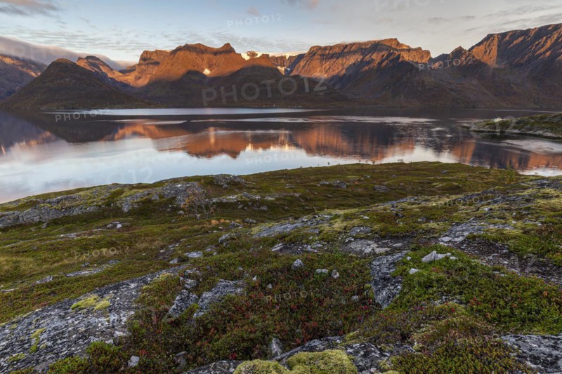 Fjord with steep mountains in autumn, morning light, clouds, Oksfjord, Finnmark, Norway