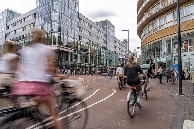 Central cycle path on the Lange Viestraat, in the centre of Utrecht, lanes for pedestrians, cyclists and cars are separated, heavy traffic, Netherlands