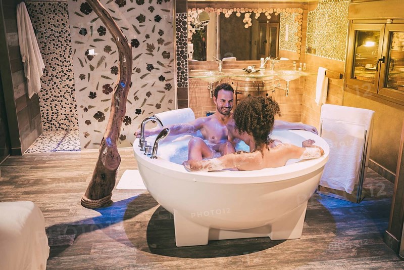 Happy young interracial couple relaxed enjoying their self in the jacuzzi