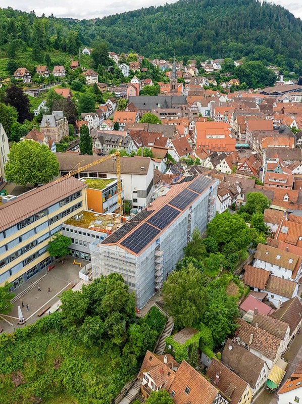 City view with solar roof and surrounding houses and vegetation, new PV system at Heinrich-Immanuel-Perrot secondary school, city of Calw, Germany