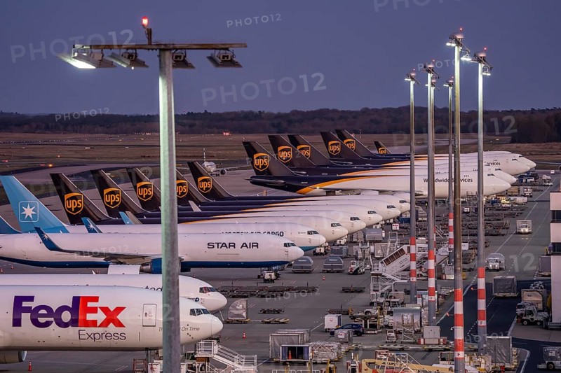 Cologne-Bonn airport, CGN, air freight center, UPS Logisic Hub, UPS cargo aircraft on the apron, FedEx and Star Air Cargo aircraft, Maersk, at the logistics center, in the evening