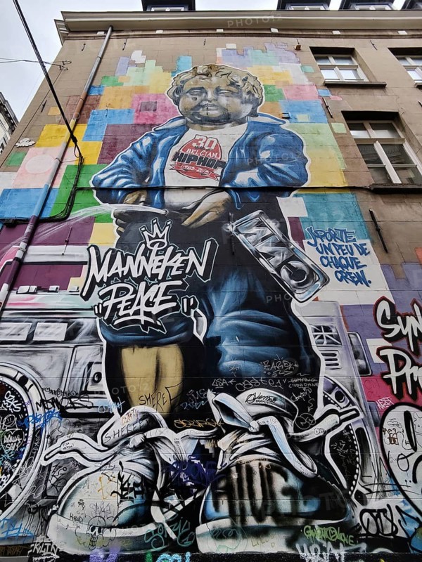 Museum GardeRobe Manneken Pis with street art mural Manneken Peace, Brussels, Belgium