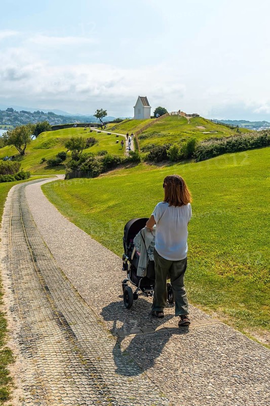 A young mother walking her son on the path in the natural park of Saint Jean de Luz called Parc de Sainte Barbe, Col de la Grun in the French Basque country. France