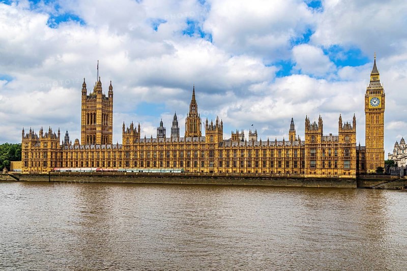 The Palace of Westminster, home to the UK Parliament, extends along the riverside with Elizabeth Tower rising at its eastern end. Much of the Gothic Revival building was designed by Charles Barry and Augustus Pugin after an 1834 fire destroyed the old palace, London, England, United Kingdom