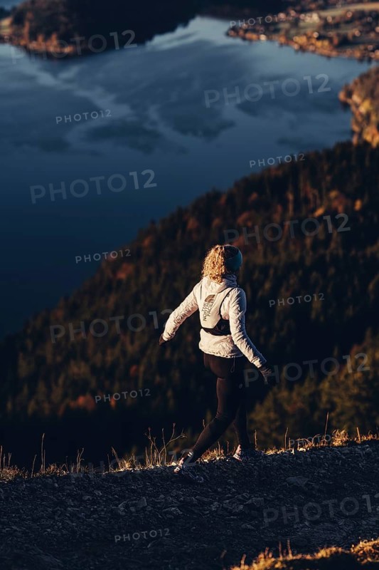 Trail running in autumn on the Jochberg on Lake Walchensee against the wonderful backdrop of the Alps, Bavaria, Germany