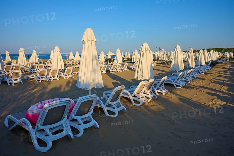 Empty sandy beach with set up white sun loungers and umbrellas, Evrenseki, Manavgat, Antalya, Turkish Riviera, Mediterranean Sea, Turkey