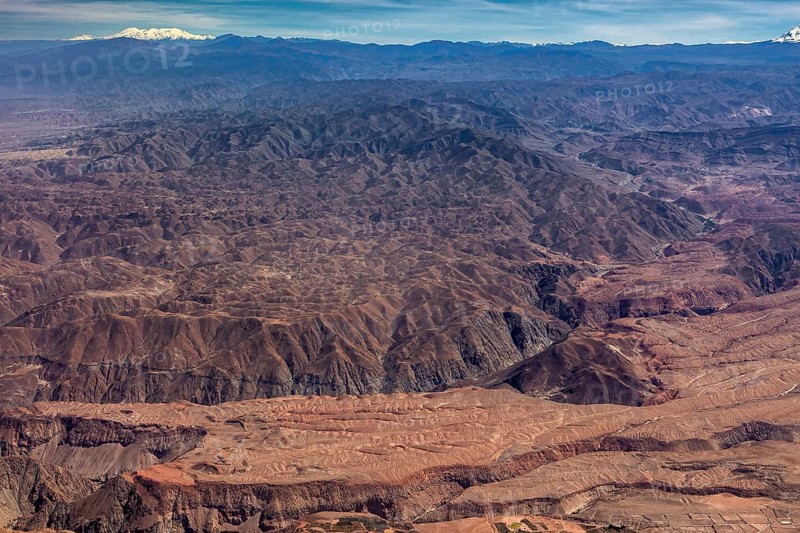 Vast, rocky mountainous area with deep canyons and reddish hues, the landscape and desert near Nasca in the Andes of Peru
