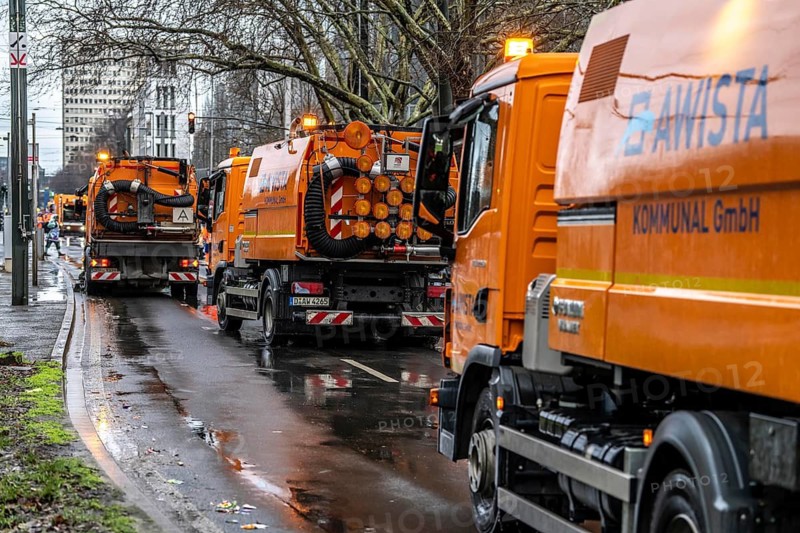 Sweeping on Rose Monday in Düsseldorf, the municipal utilities clean up after the train, confetti, camels, trash, employees with sweepers from AWISTA, Society for Waste Management and City Cleaning, central disposal and urban cleaning companies in Düsseldorf, clean the train's path with their street cleaning machines, North Rhine-Westphalia, Germany