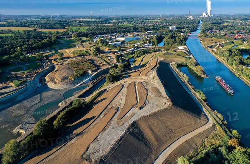 Recklinghausen, Castrop-Rauxel, North Rhine-Westphalia, Germany - EMSCHERLAND construction project, a 37-hectare water and nature discovery park at the water crossroads of the Rhine-Herne Canal (right) and the renaturalised Emscher (left) on the city limits of Recklinghausen and Castrop-Rauxel. The ecological focal point at the confluence of Suderwicher Bach and Emscher will also be a future garden for the International Garden Exhibition 2027. Before the renaturalisation, the Emscher river system was an open, above-ground wastewater canal, combined sewer with surface water and wastewater. The Uniper power plant Datteln 4 in the background