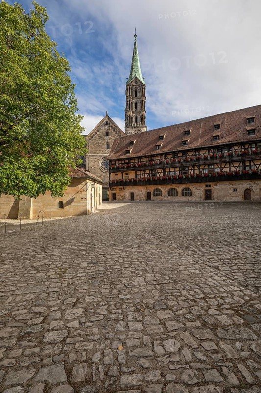 20 August 2026, The historic cobblestone courtyard of Alte Hofhaltung with the Bamberg Cathedral spire visible in Bamberg, Germany