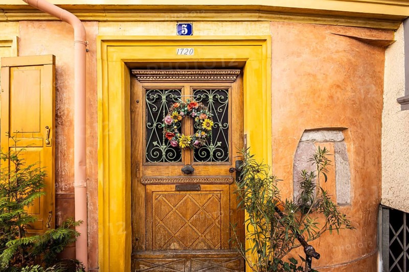 Town view with narrow alley and colourfully decorated door in the old town of Baden-Baden, Baden-Württemberg, Germany
