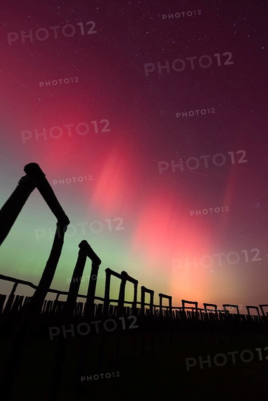 Northern lights (aurora borealis) over the ring sanctuary of Pömmelte, prehistoric circular ditch complex, also known by archaeologists as the German Stonehenge, Pömmelte, Saxony-Anhalt, Germany