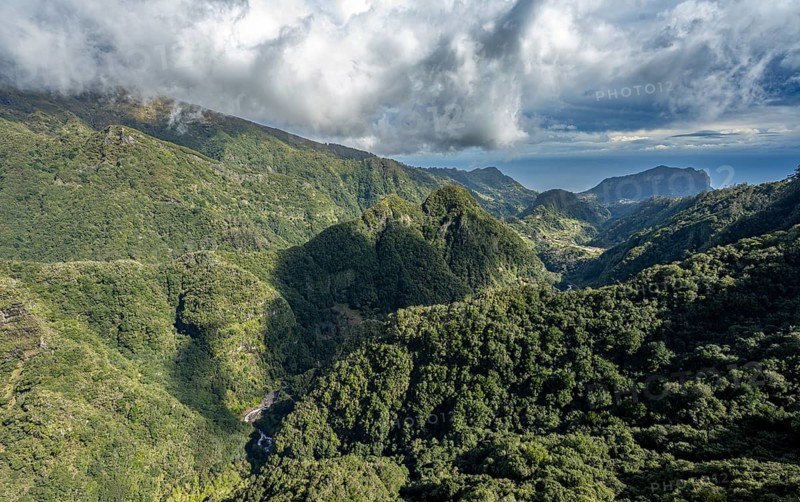 Densely overgrown steep mountains, green mountain landscape, view from the Miradouro dos Balcões, mountain valley Ribeira da Metade and the central mountains, Madeira, Portugal