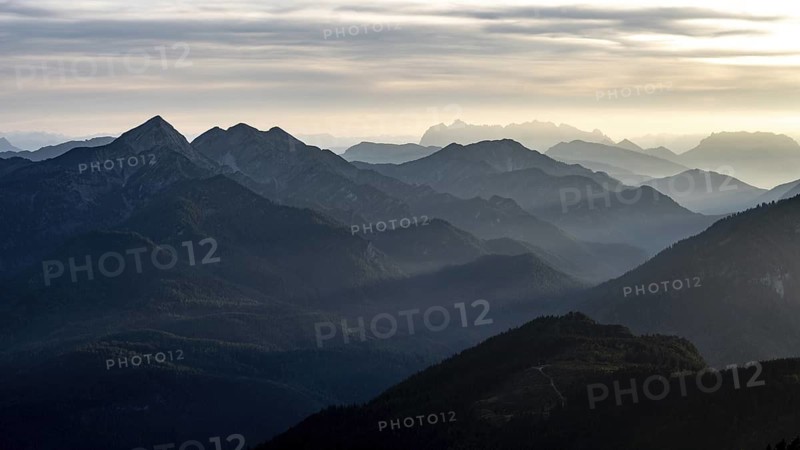 View at sunset from the summit of Zwiesel to the Chiemgau Alps with the Sonntagshorn and to the Wilder Kaiser, Chiemgau, Bavaria, Germany