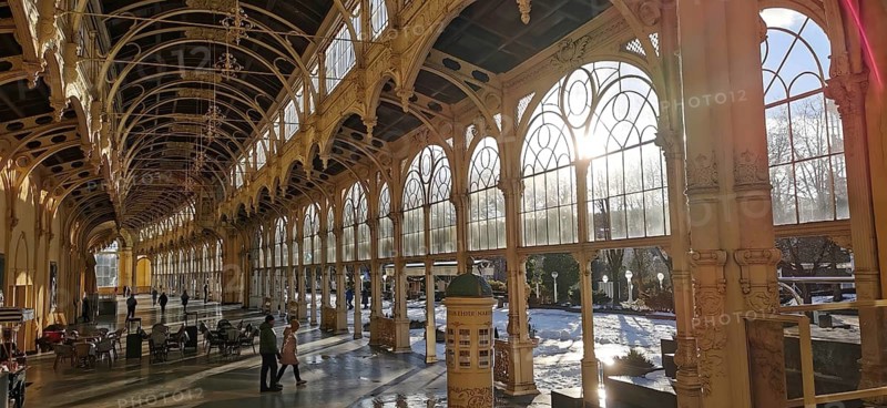 Large window front in elegant historic arcades filled with warm sunlight, Maxim Gorky Kollonade, Marianske Lazne main colonade, Marianske Lazne, Czech Republic