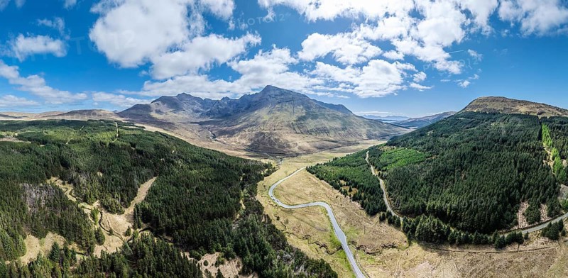 Aerial panoramic drone photo landscape of the Black Cuillins mountain chain with the tourist attraction of the fairy pools, Isle of Skye, Scotland, UK
