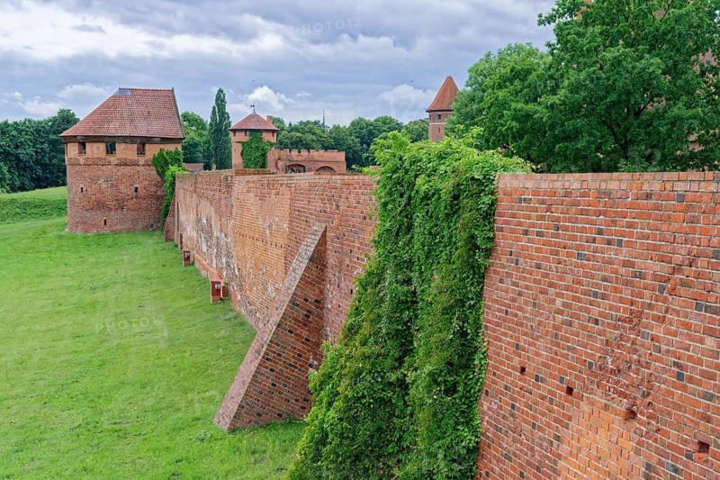 Castle wall and external fortifications of Malbork. The Malborku Castle, Zamek w Malborku, is a neo-Gothic lowland castle built by the Teutonic Order, and is a UNESCO World Heritage Site. Malbork, Pomerania, Poland