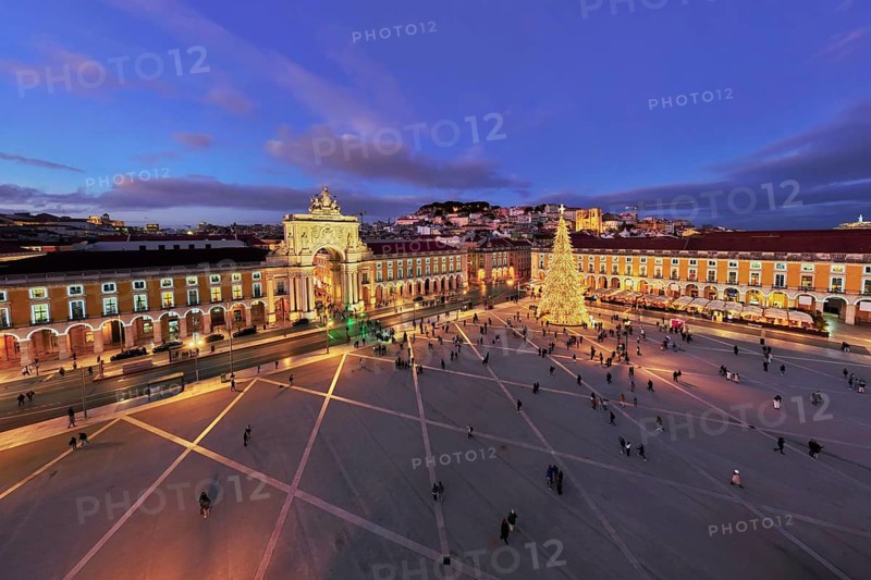 Praca do Comercio showcases a stunning Christmas tree and decorations, captivating visitors in the evening light of winter