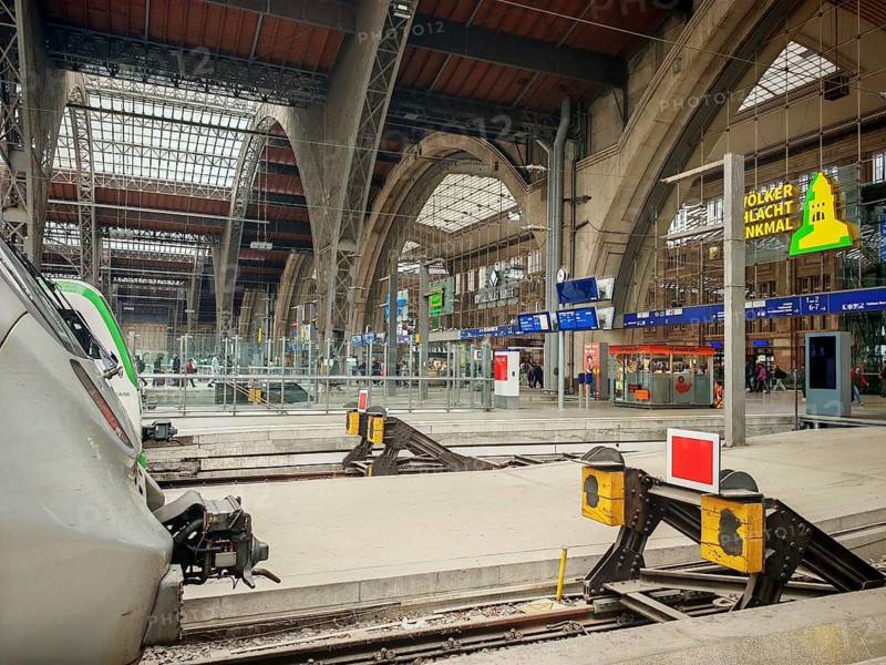 Modern track areas of a train station with covered glass roofs, train station, Leipzig main station