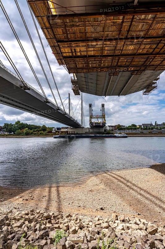 New construction of the second part of the Neuenkamp motorway bridge of the A40, across the Rhine near Duisburg, parallel to the existing first bridge, freighter on the Rhine, North Rhine-Westphalia, Germany