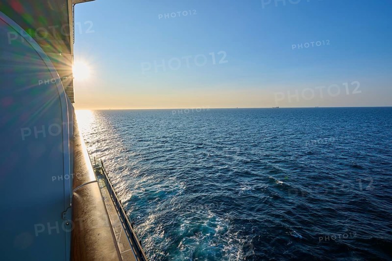 View from cruise ship, Mein Schiff 6, onto the wide sea at sunrise, under a clear blue sky, autumn, North Sea, Denmark