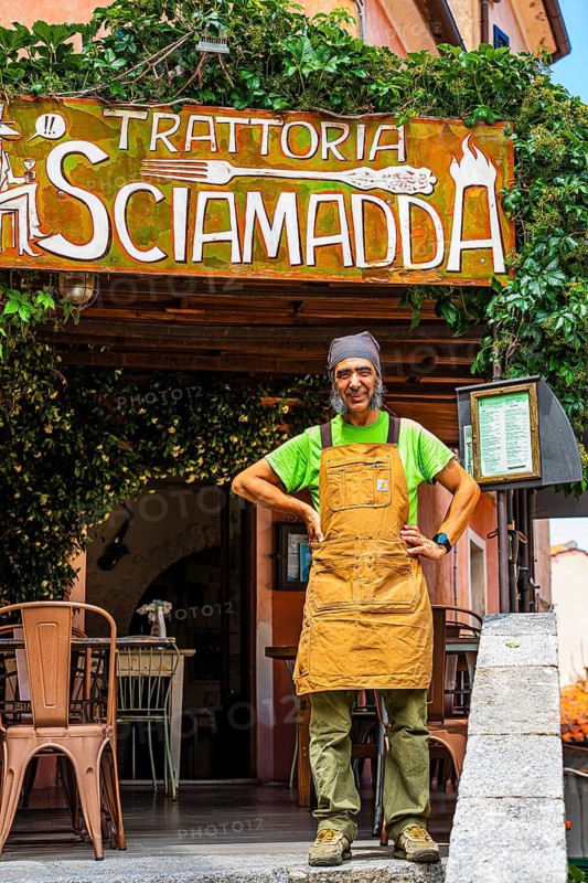 The landlord of the Trattoria Sciamadda, waiting for guests, mountain village of Poggio, Elba Island, Tuscan Archipelago National Park, Tuscany, Italy