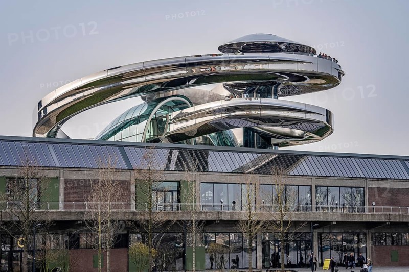 The Fenix Museum of Contemporary Art about migration, in a former warehouse on the Nieuwe Maas, walk-in spiral staircase made of polished stainless steel, in the shape of a double helix, called tornado, 550 meters long from ground floor to a viewing platform on the roof, with a view of the Rotterdam skyline, architect Ma Yansong, the Netherlands